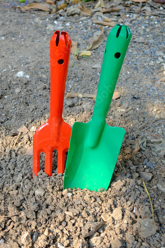 Garden hand fork and shovel stabs on the ground