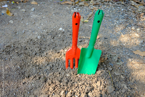 Garden hand fork and shovel stabs on the ground