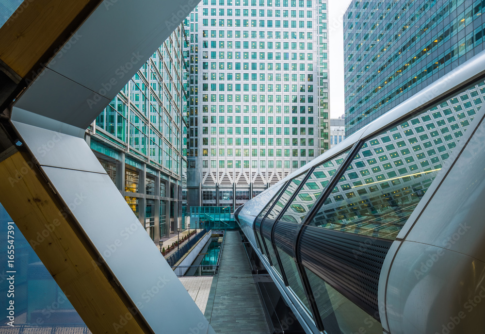 London, England - Public pedestrian cross rail footbridge at the financial district of Canary Wharf with skyscrapers