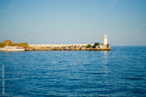 Wharf and lighthouse on the sea