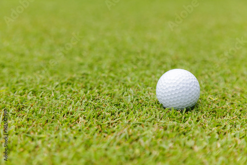Golf ball on green grass on golf course
