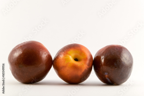 organic red and yellow plums.