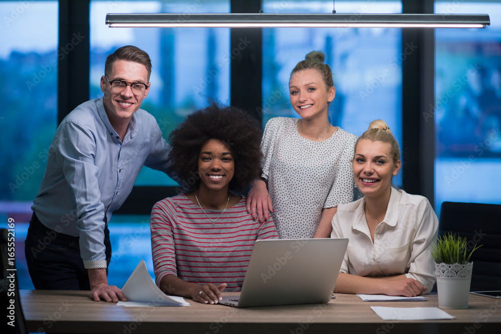 Multiethnic startup business team in night office