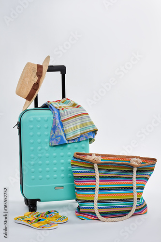 Summer accessorries for beach. Bright clothes and suitcase. photo