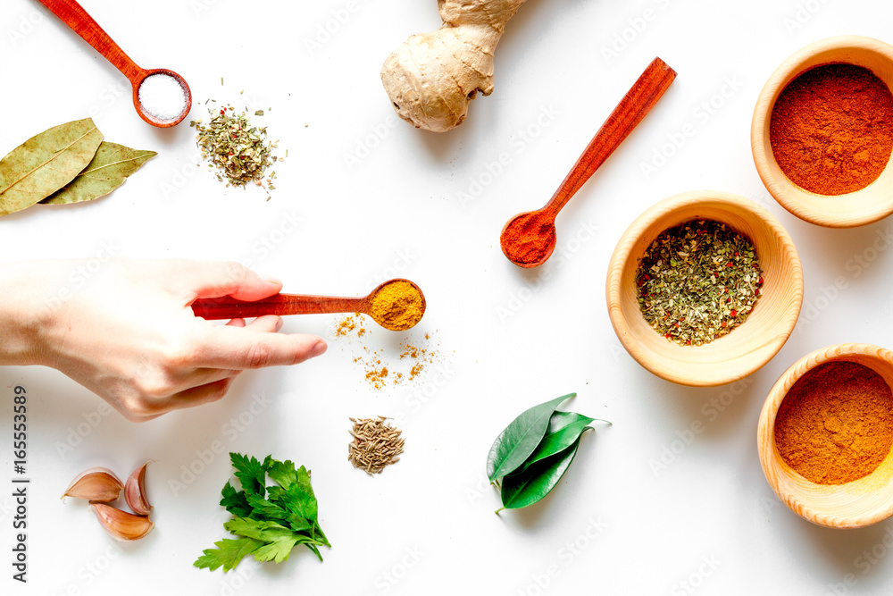 spices in wooden spoons on white background top view spices in wooden spoons on white background top view