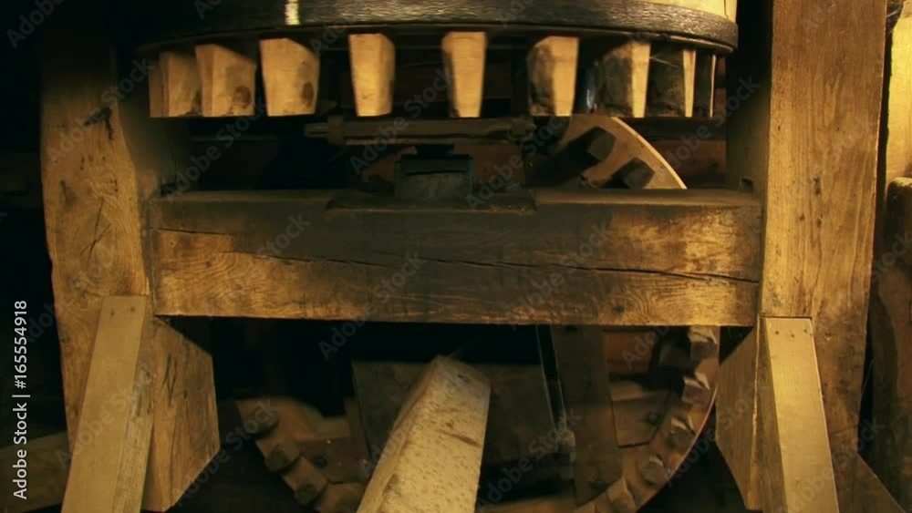 Cogwheels rotate in a 90-degree angle in an industrial corn mill. Sound of creaking and groaning of the timber Cogwheels rotate in a 90-degree angle in an industrial corn mill. Sound of creaking and groaning of the timber