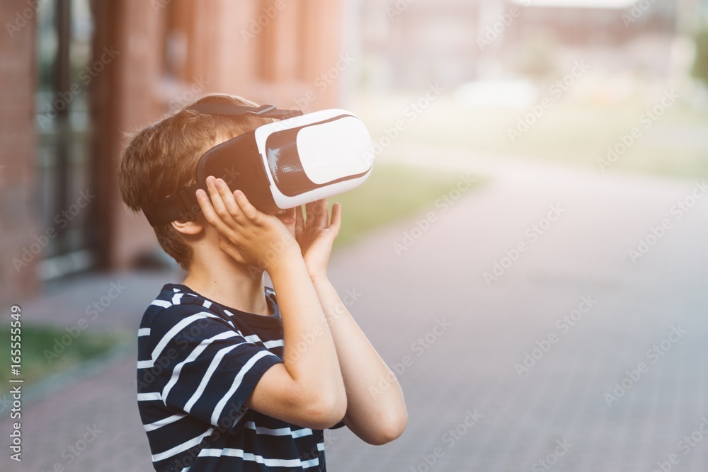 Boy watching simulation in virtual reality googles