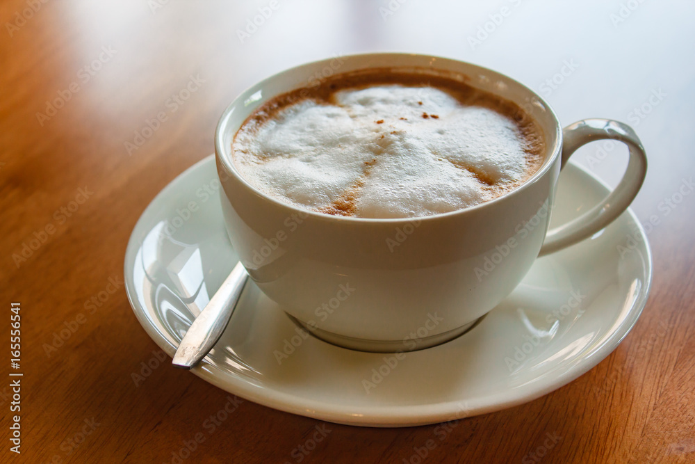 Hot cappuccino cup on wood table. Hot cappuccino cup on wood table.