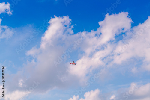 Abstract blur Blue sky  with Sea plane flying above Maldives islands . photo