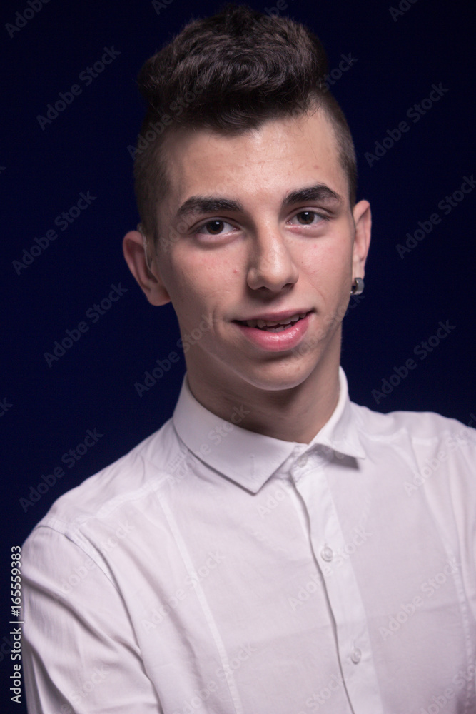 Obraz premium One teenager boy, head and shoulders shot, white shirt, earring