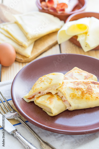 Food, Homemade Crepes with Ham and Cheese on Rustic Table, Vertical View photo