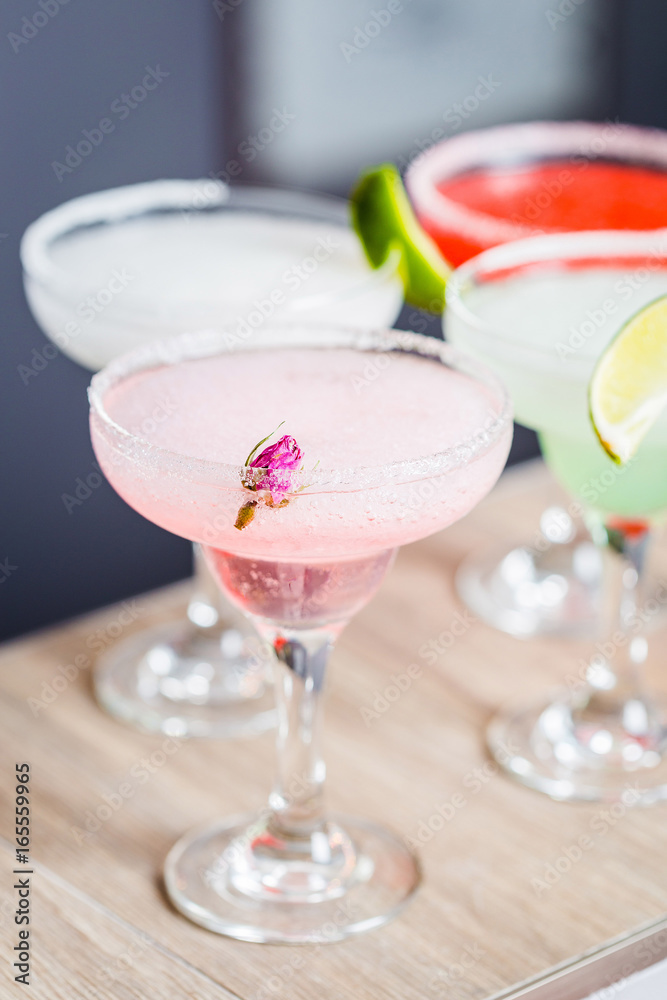 Different Kind of Cocktails garnished with Fruits, Focus on Foreground, Vertical View Different Kind of Cocktails garnished with Fruits, Focus on Foreground, Vertical View