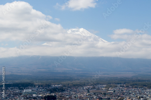 Mount Fuji that is the famous landmark in Japan with white cloud on blue sky background