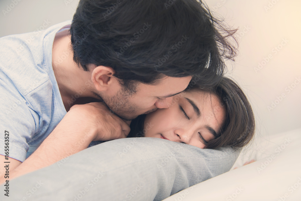 Young couple sleeping and relaxing on the bed in bedroom Young couple sleeping and relaxing on the bed in bedroom
