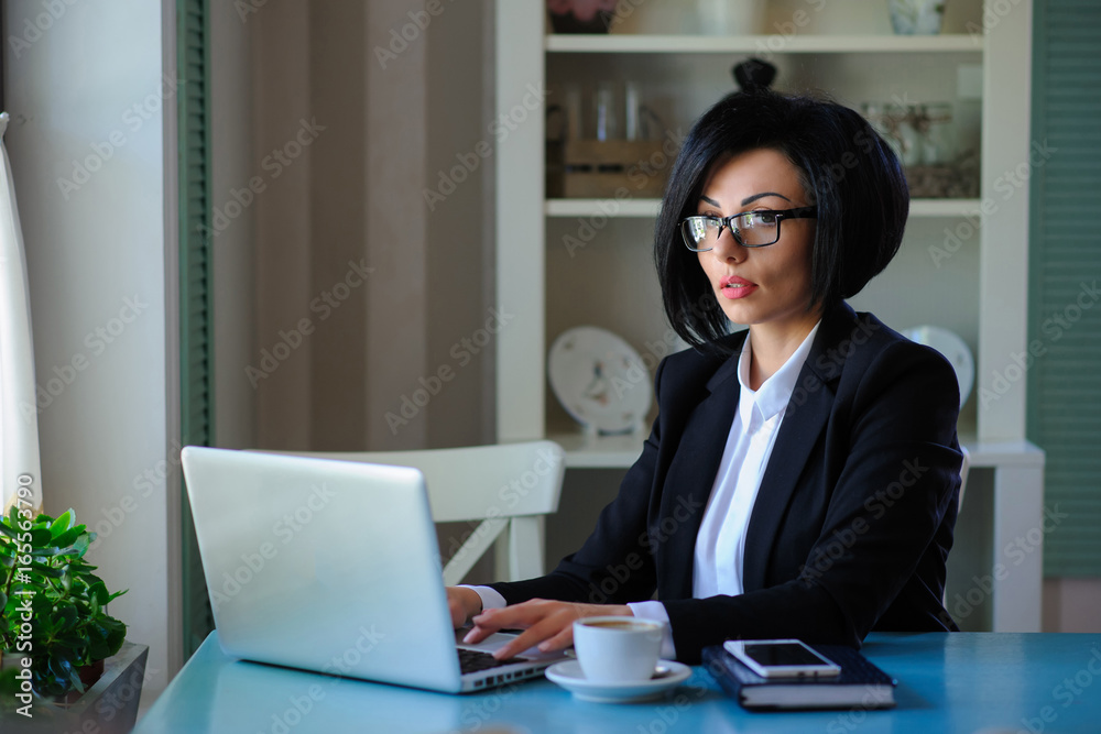 business lady with glasses dressed in black suit working on a laptop business lady with glasses dressed in black suit working on a laptop