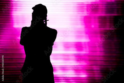 Silhouette of an artist singing live on the stage