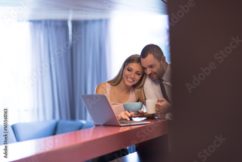 A young couple is preparing for a job and using a laptop