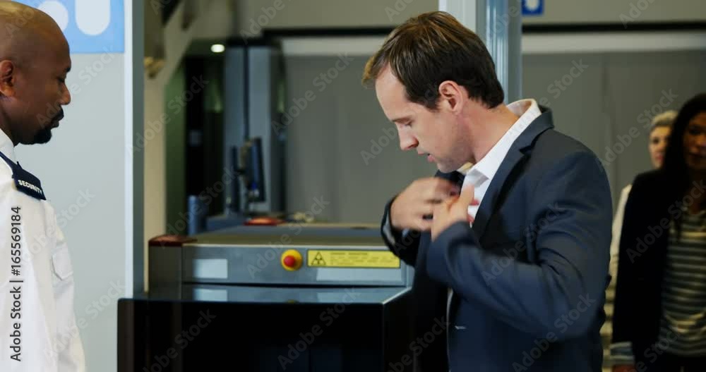 Passenger going through a airport security check Passenger going through a airport security check