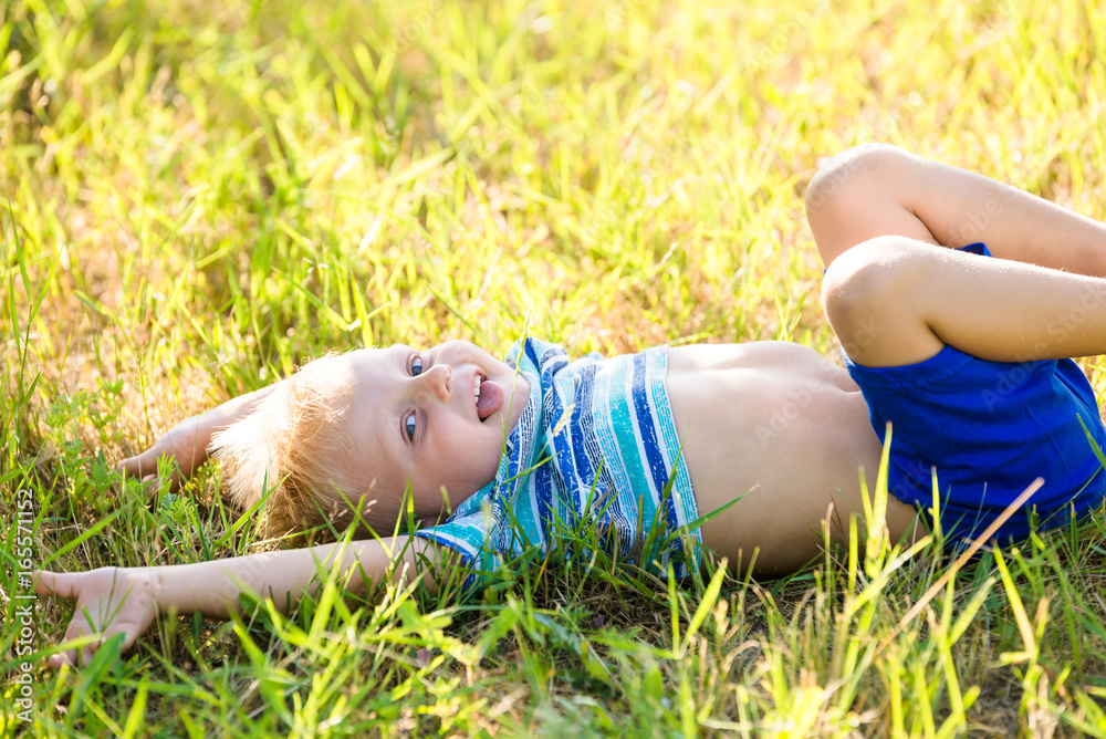 Very cheerful little boy in the garden Very cheerful little boy in the garden