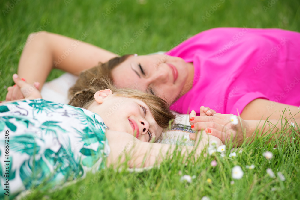 Mother and daughter playing in park Mother and daughter playing in park