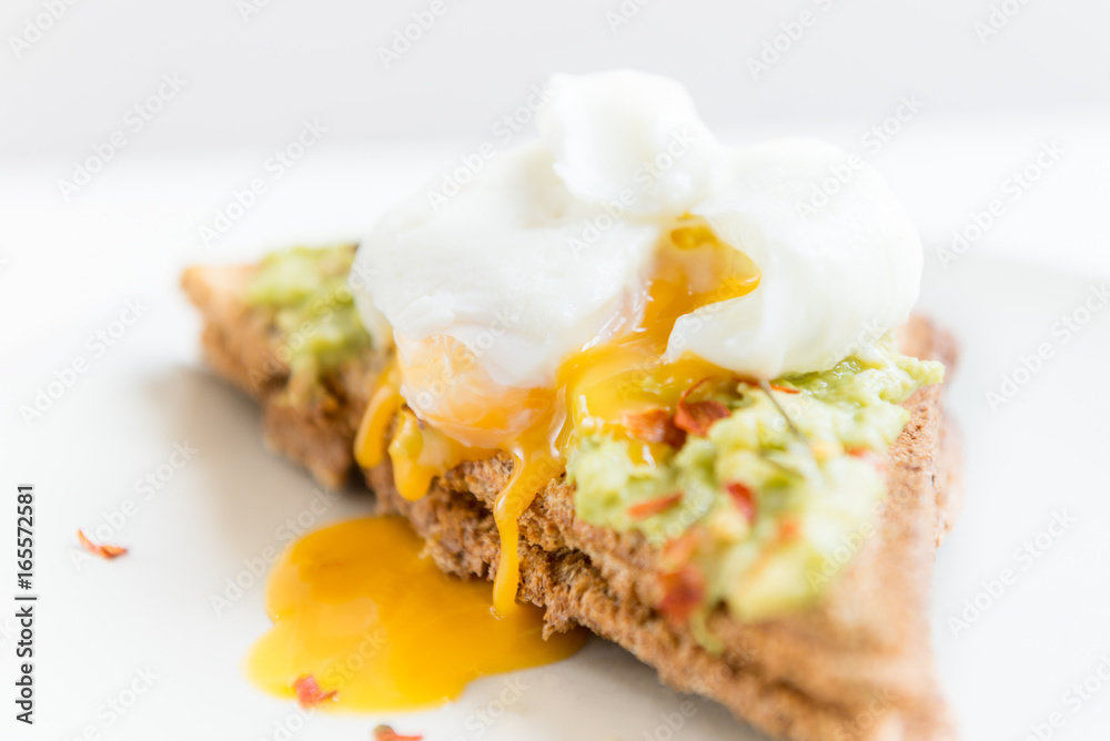 Wholemeal Bread Toast and Poached Egg with mashed avocado and ch Wholemeal Bread Toast and Poached Egg with mashed avocado and ch
