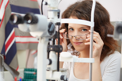 Fototapeta Naklejka Na Ścianę i Meble -  pretty young woman having her eyes examined by an eye doctor
