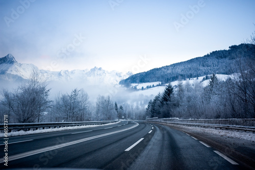 The snowy road in the winter landscape, early in the morning