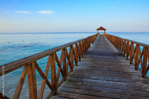 Beach of caribbean sea and wooden pier .