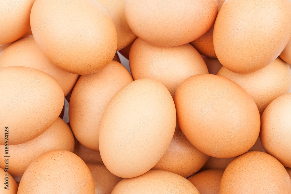 Background with fresh brown chicken eggs close-up Background with fresh brown chicken eggs close-up