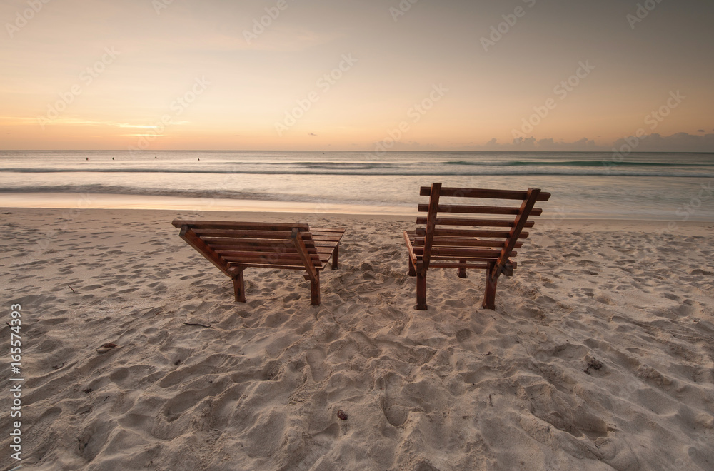 Relaxing chair on the beach during sunset