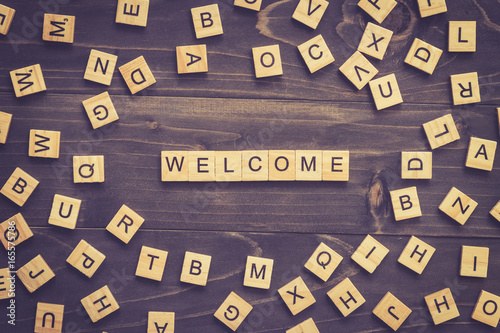 Fotografie Welcome word wood block on table for business concept.