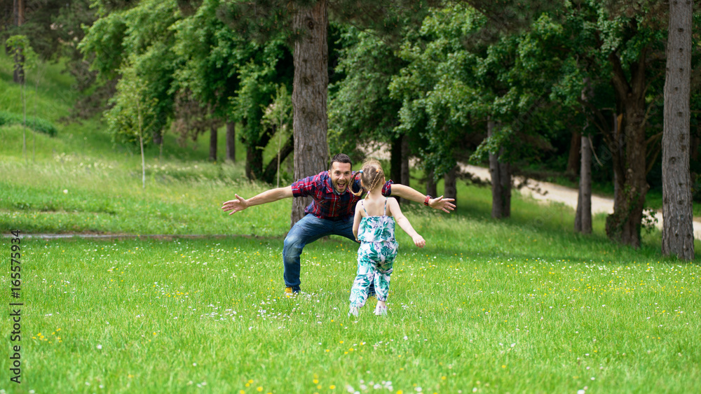 Fototapeta premium Father and daughter playing in park
