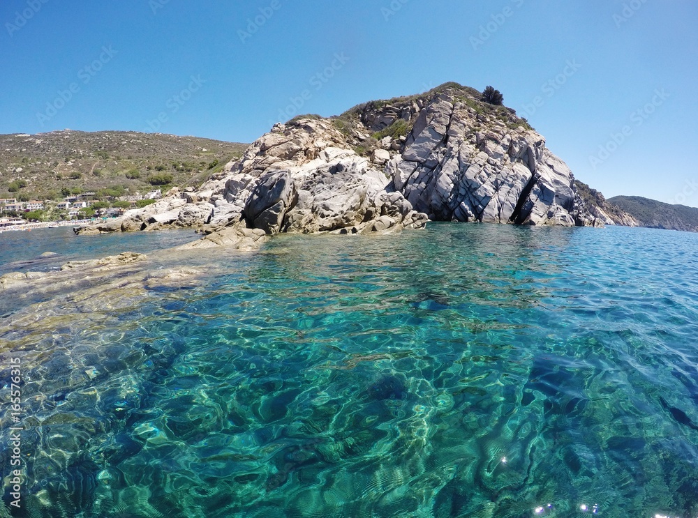 Fototapeta premium Crystal clear water in Cavoli beach, Elba island, Italy
