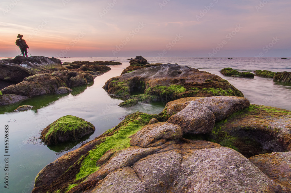 Rocks covered by green moss during sunset. image contain soft focus due to long exposure. Rocks covered by green moss during sunset. image contain soft focus due to long exposure.