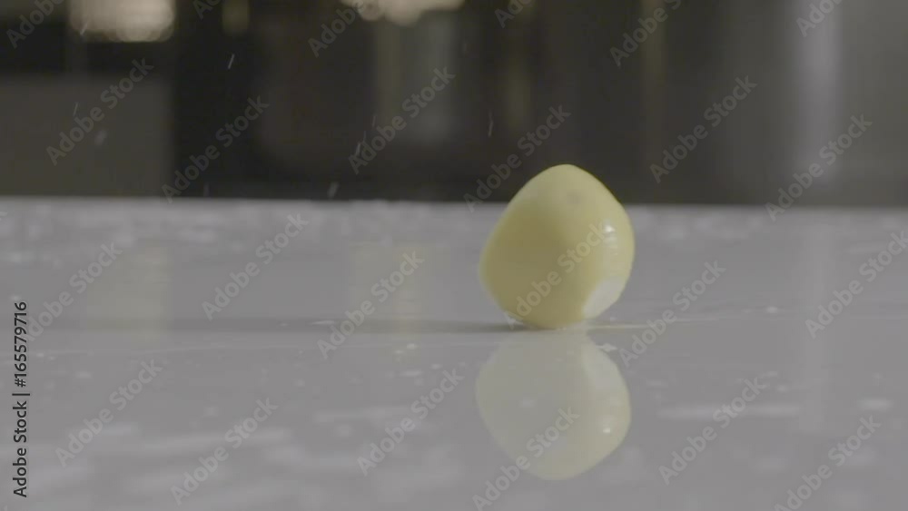 half cut lemons sliding from left to right on a wet white kitchen table