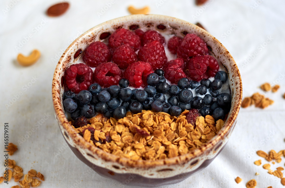 Bowl of homemade granola with yogurt and fresh berries on white background. Top view. Collection Bowl of homemade granola with yogurt and fresh berries on white background. Top view. Collection