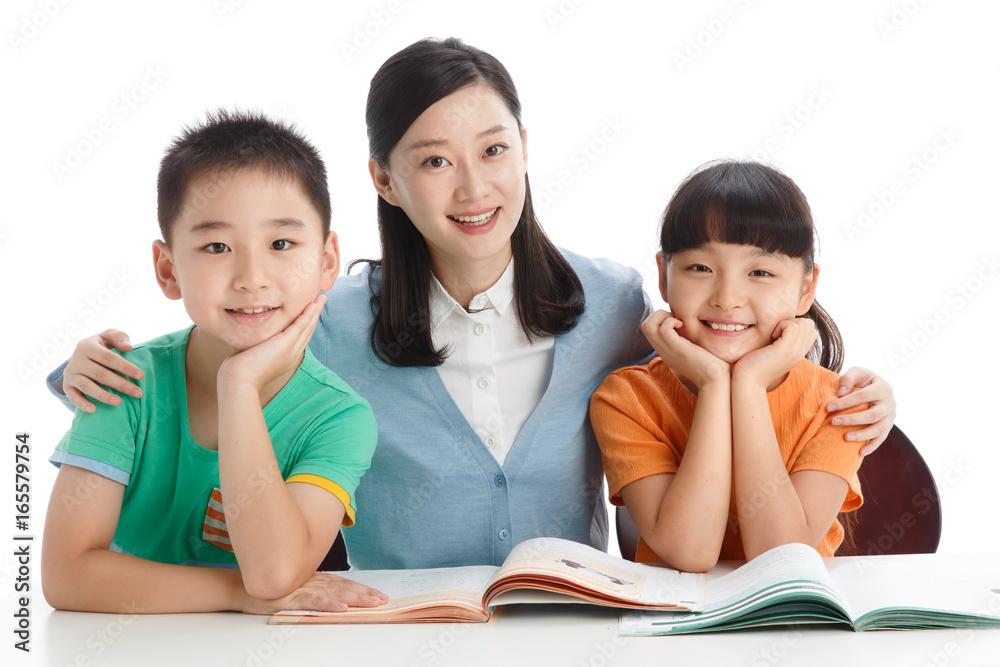 Female teacher helping students study in classroom