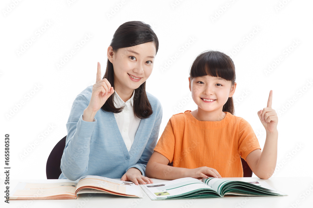 Female teacher helping school girl study Female teacher helping school girl study
