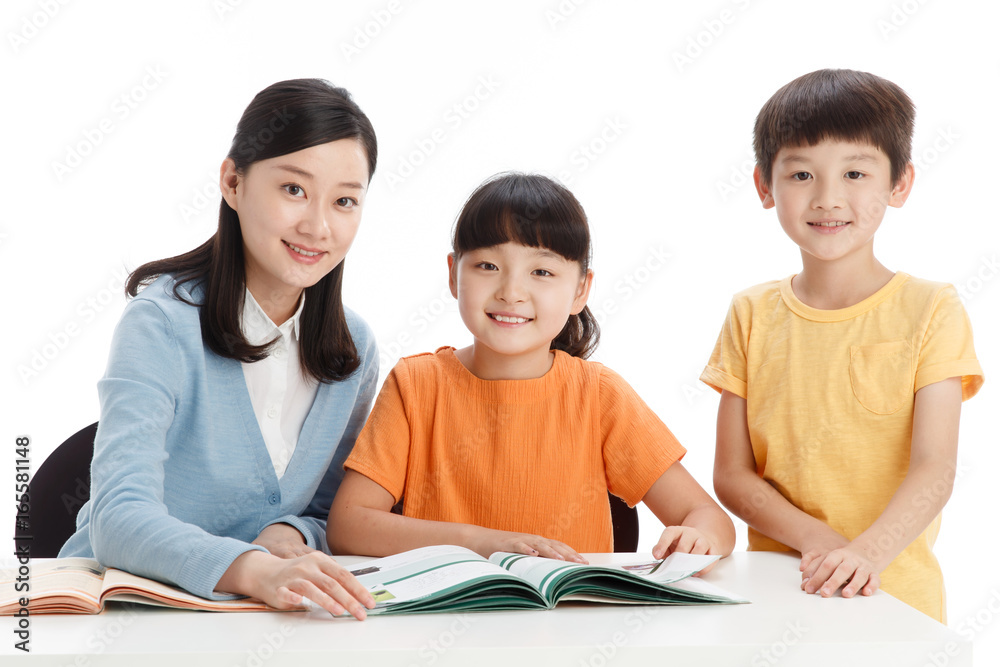 Female teacher helping students study in classroom Female teacher helping students study in classroom