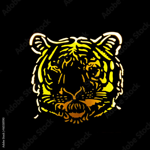 Fototapeta Naklejka Na Ścianę i Meble -  Backlit metal cutout of a tiger face