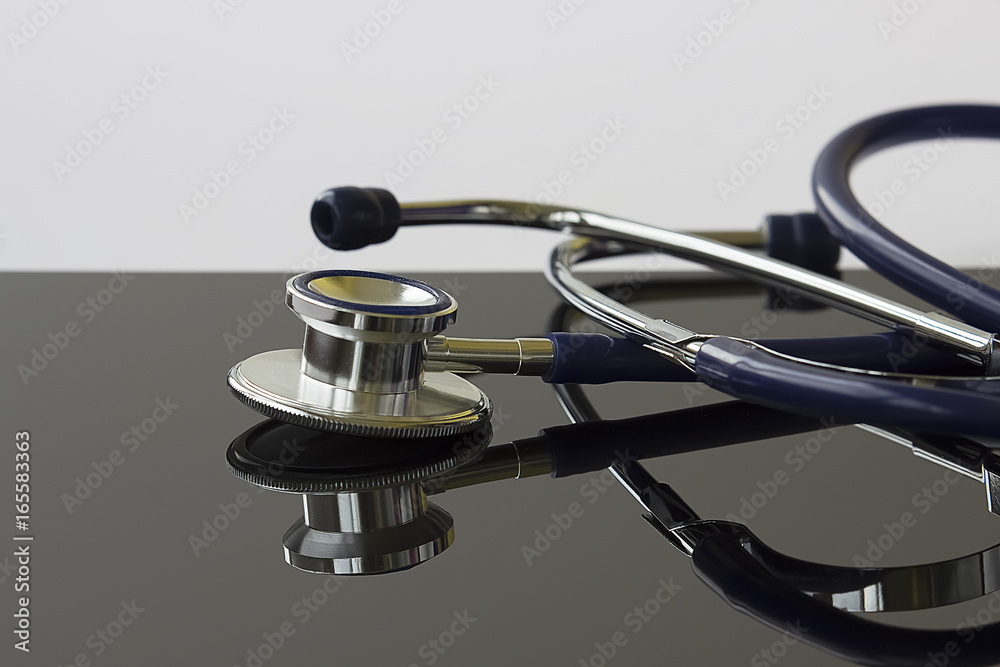 Stethoscope with reflection. Stethoscope with reflection on glossy gray background. Concept of medicine and health care. Stethoscope with reflection. Stethoscope with reflection on glossy gray background. Concept of medicine and health care.