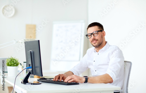 businessman typing on computer keyboard at office