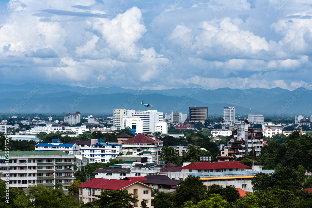 High-angle view of the city with buildings, airports, and mountains in the background. High-angle view of the city with buildings, airports, and mountains in the background.