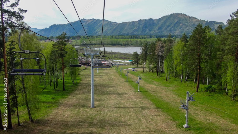 Ropeway in the gorge of the mountain altai in the summer Ropeway in the gorge of the mountain altai in the summer
