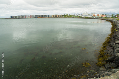 Iceland - Hafnarfjördur Harbor with houses and water photo