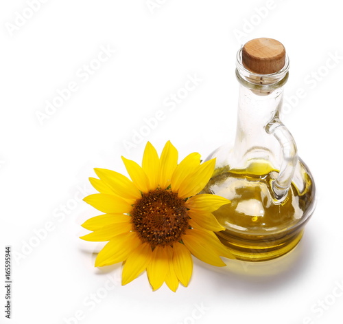 Sunflower and glass bottle of oil isolated on white background