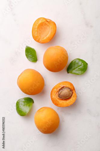 Fototapeta Apricots on marble background viewed from above