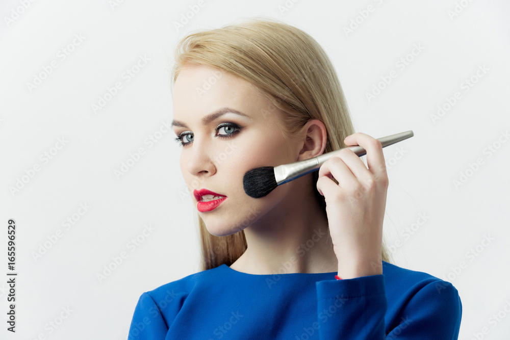 Girl with makeup brush applying powder on face Girl with makeup brush applying powder on face