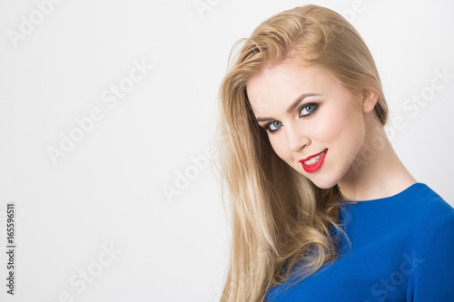 Happy woman with red lips smiling in blue dress