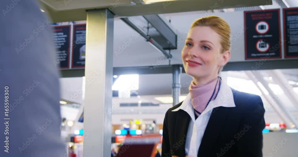 Businessman showing his boarding pass at the check-in counter